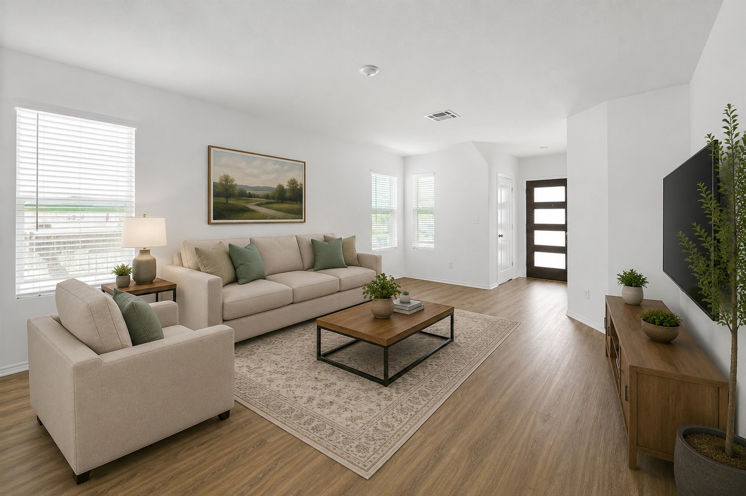 120 Milliner Loop Hutto, TX 78634 - Photo 3 of 15 Sun-filled living room featuring resilient hardwood flooring and an inviting open-concept layout.