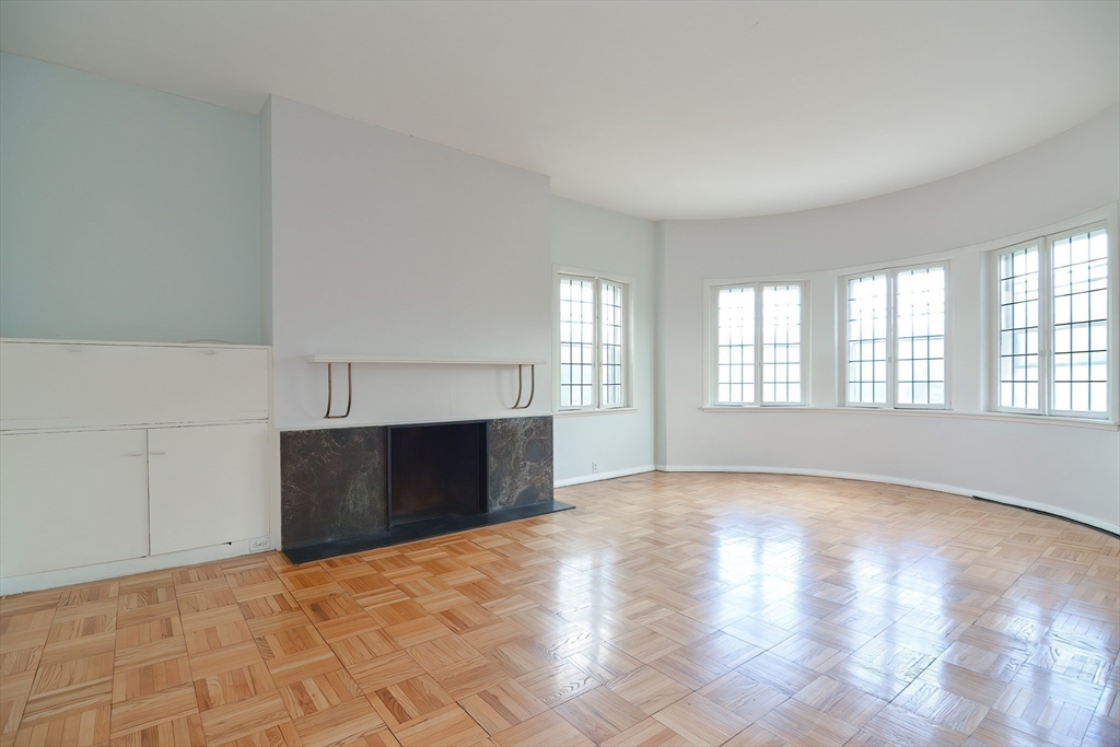 923 Beacon Street, Unit 2 Boston, MA 02215 - Photo 3 of 11 a view of an empty room with a window and fireplace