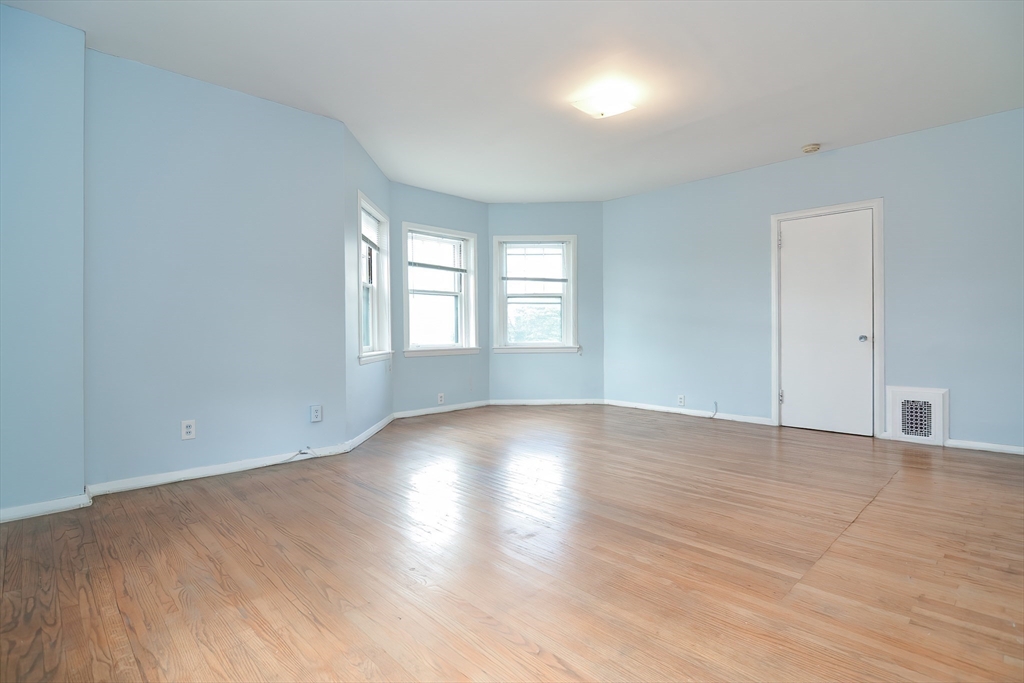 923 Beacon Street, Unit 2 Boston, MA 02215 - Photo 6 of 11 a view of empty room with wooden floor and fan
