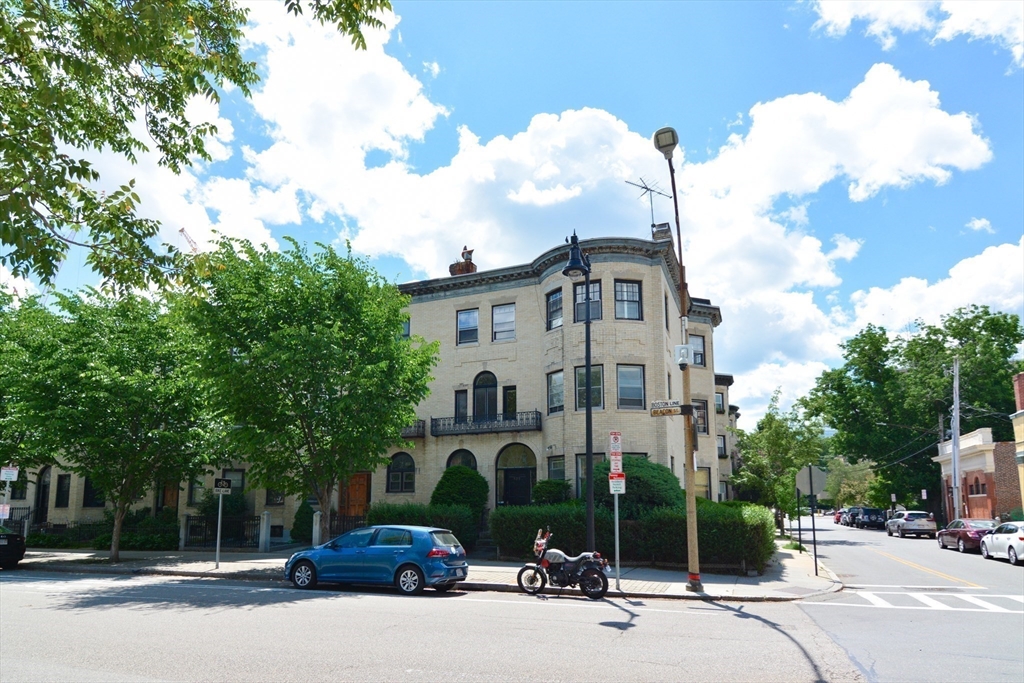 923 Beacon Street, Unit 2 Boston, MA 02215 - Photo 10 of 11 a couple of cars parked in front of a building