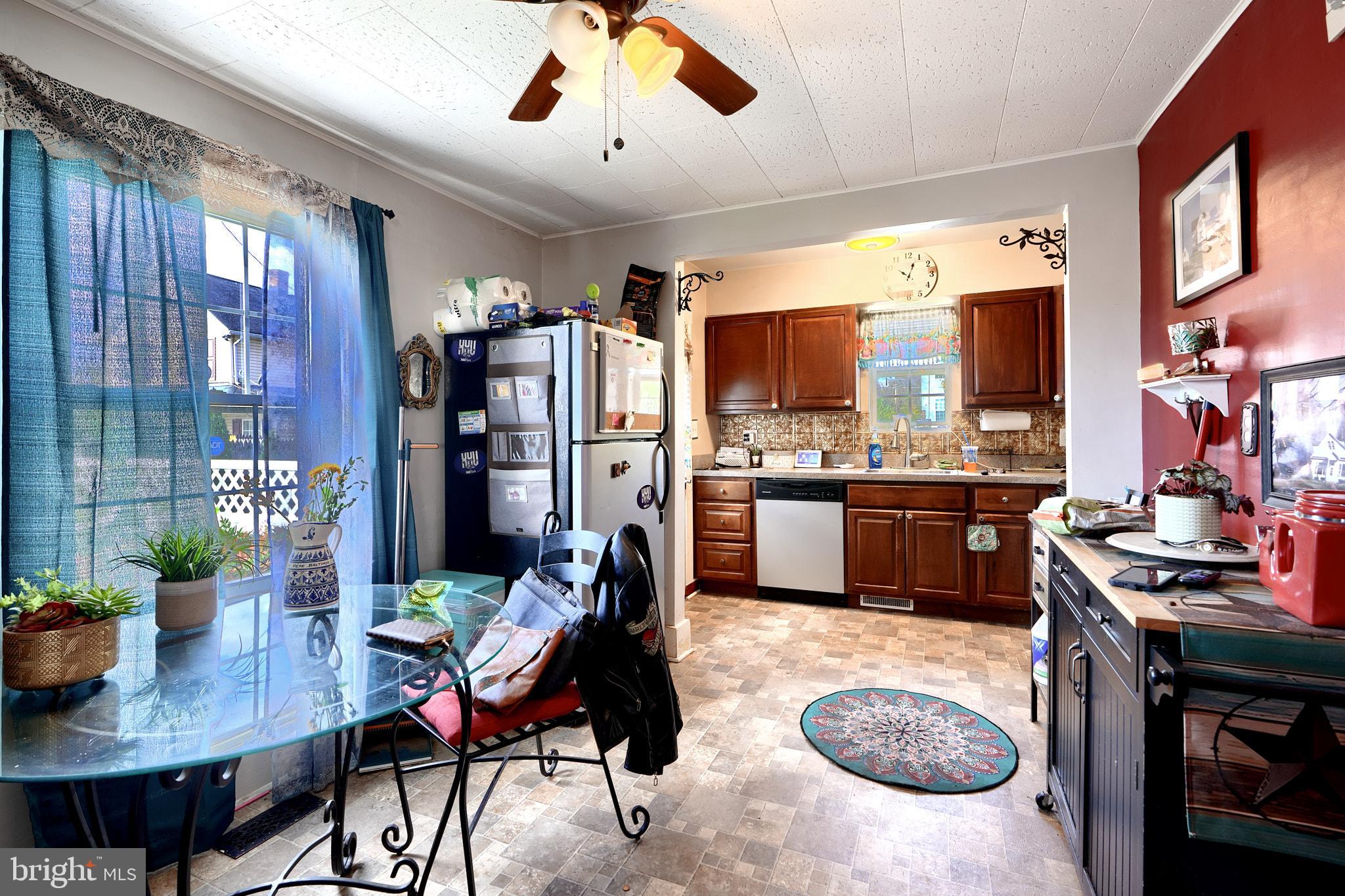 10816 Red Lion Road White Marsh, MD 21162 - Photo 13 of 39 a living room with stainless steel appliances furniture a rug and a kitchen view