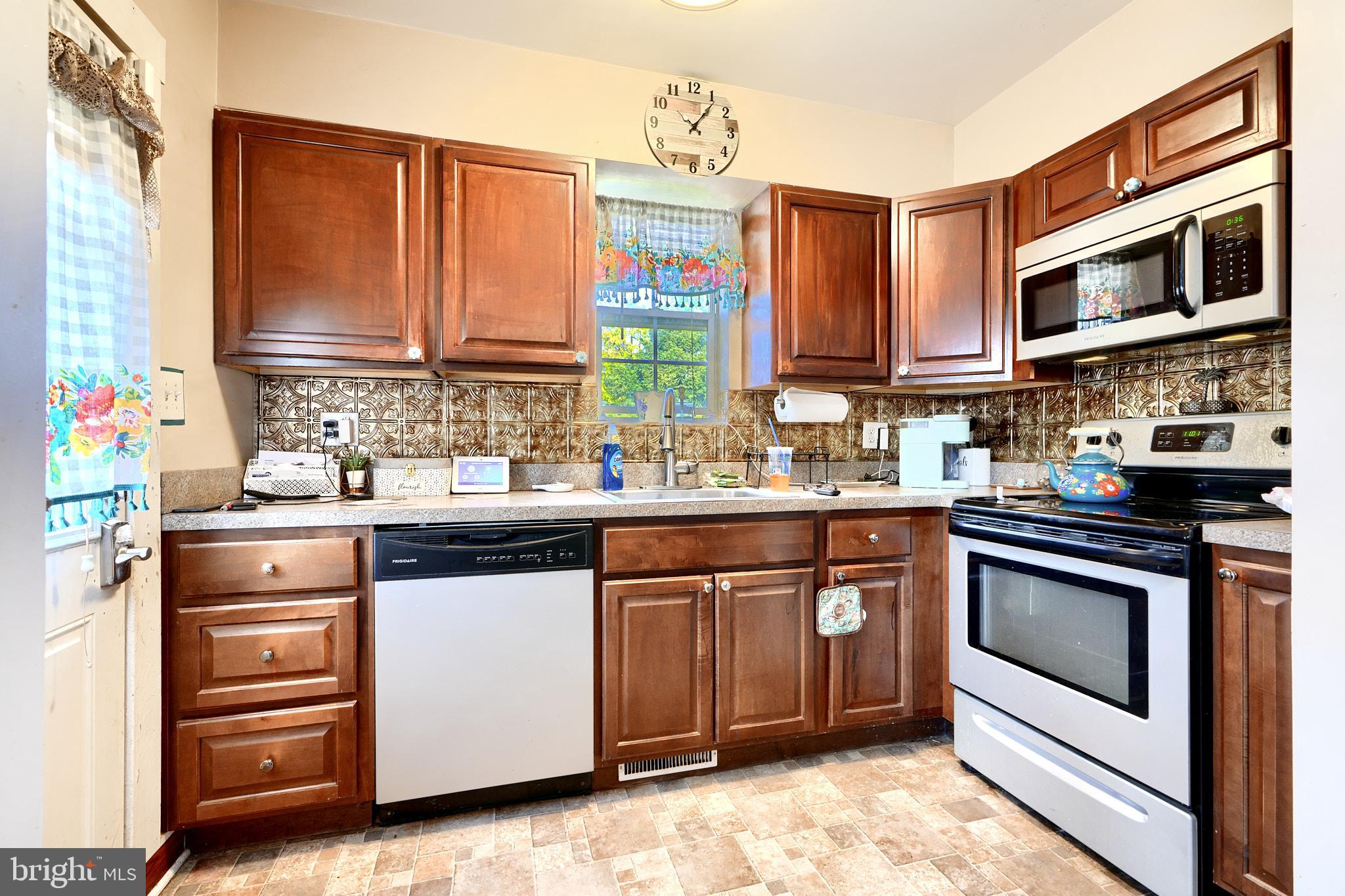 10816 Red Lion Road White Marsh, MD 21162 - Photo 16 of 39 a kitchen with stainless steel appliances granite countertop a stove and cabinets