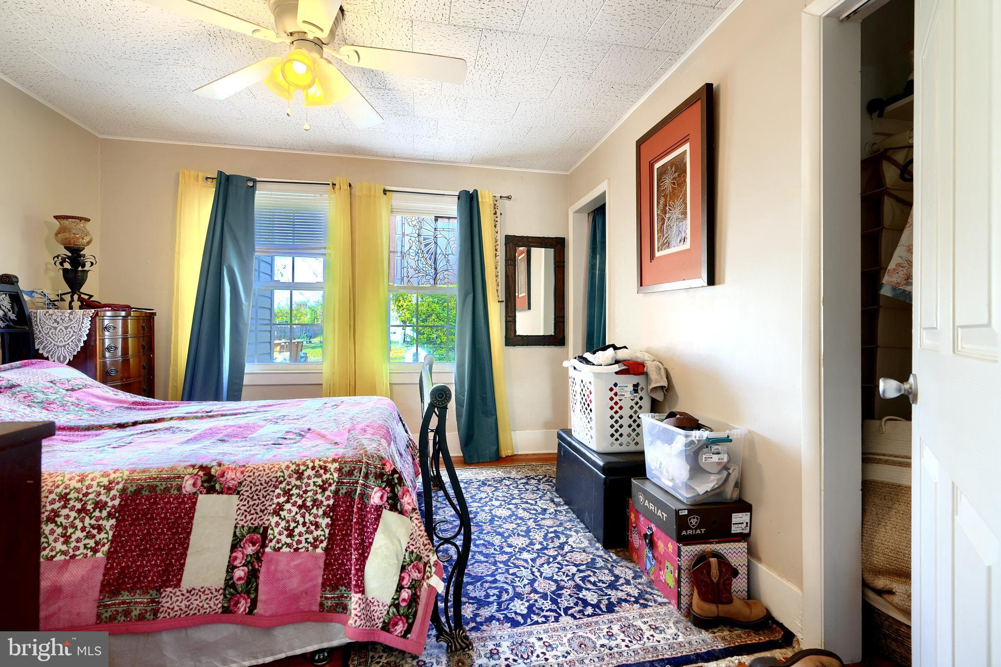 10816 Red Lion Road White Marsh, MD 21162 - Photo 20 of 39 a bedroom with a bed a dresser and next to a window
