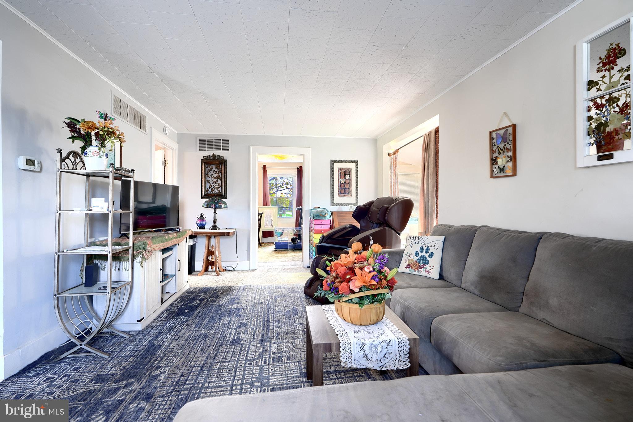 10816 Red Lion Road White Marsh, MD 21162 - Photo 5 of 39 a living room with furniture and a flat screen tv