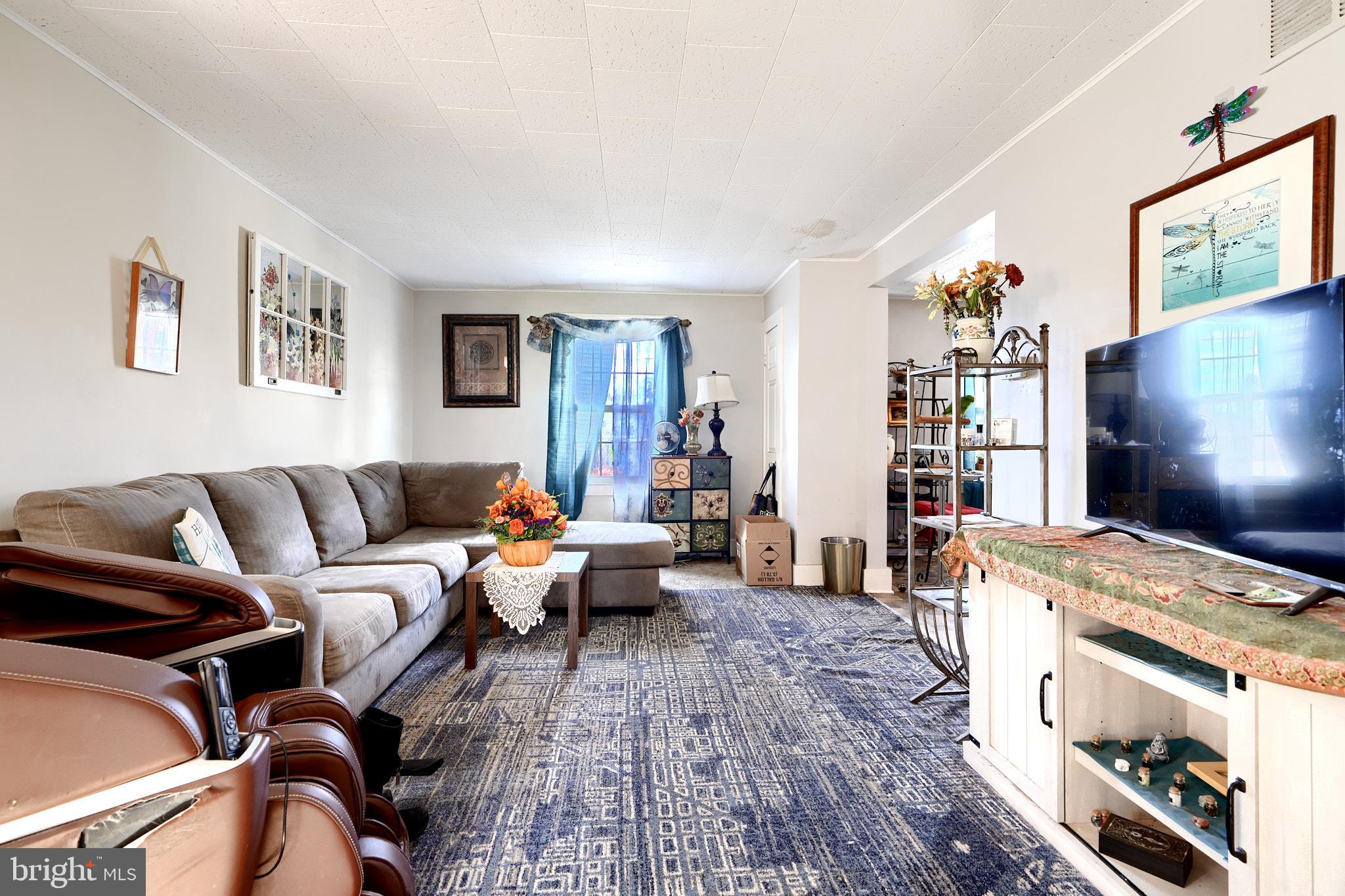10816 Red Lion Road White Marsh, MD 21162 - Photo 7 of 39 a living room with furniture and a flat screen tv