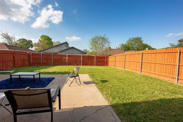 a view of backyard with a garden and outdoor seating
