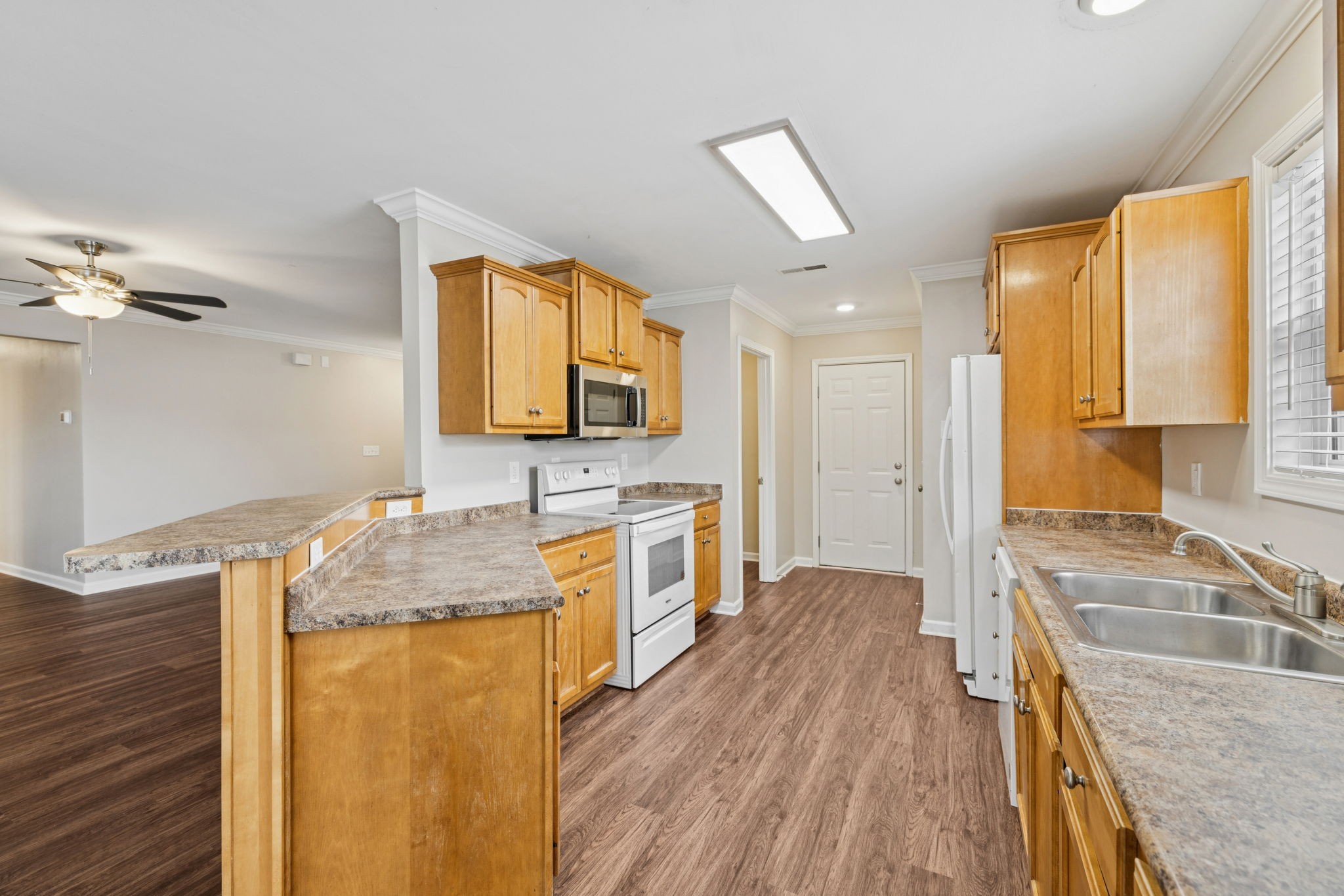 1305 Chapman Court Spring Hill, TN 37174 - Photo 21 of 53 a kitchen with a stove a sink and a refrigerator
