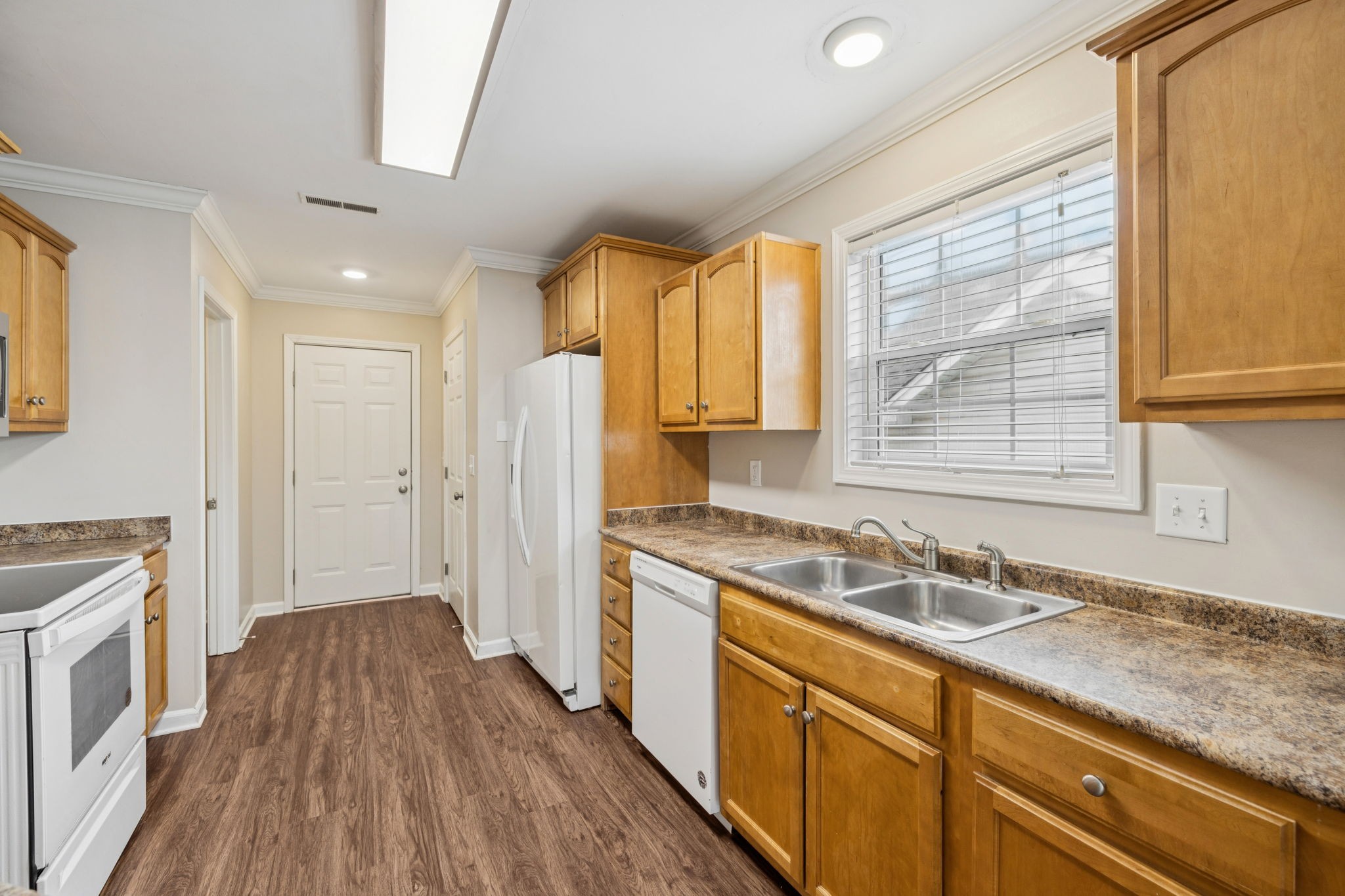 1305 Chapman Court Spring Hill, TN 37174 - Photo 22 of 53 a kitchen with a sink a stove a refrigerator and a window
