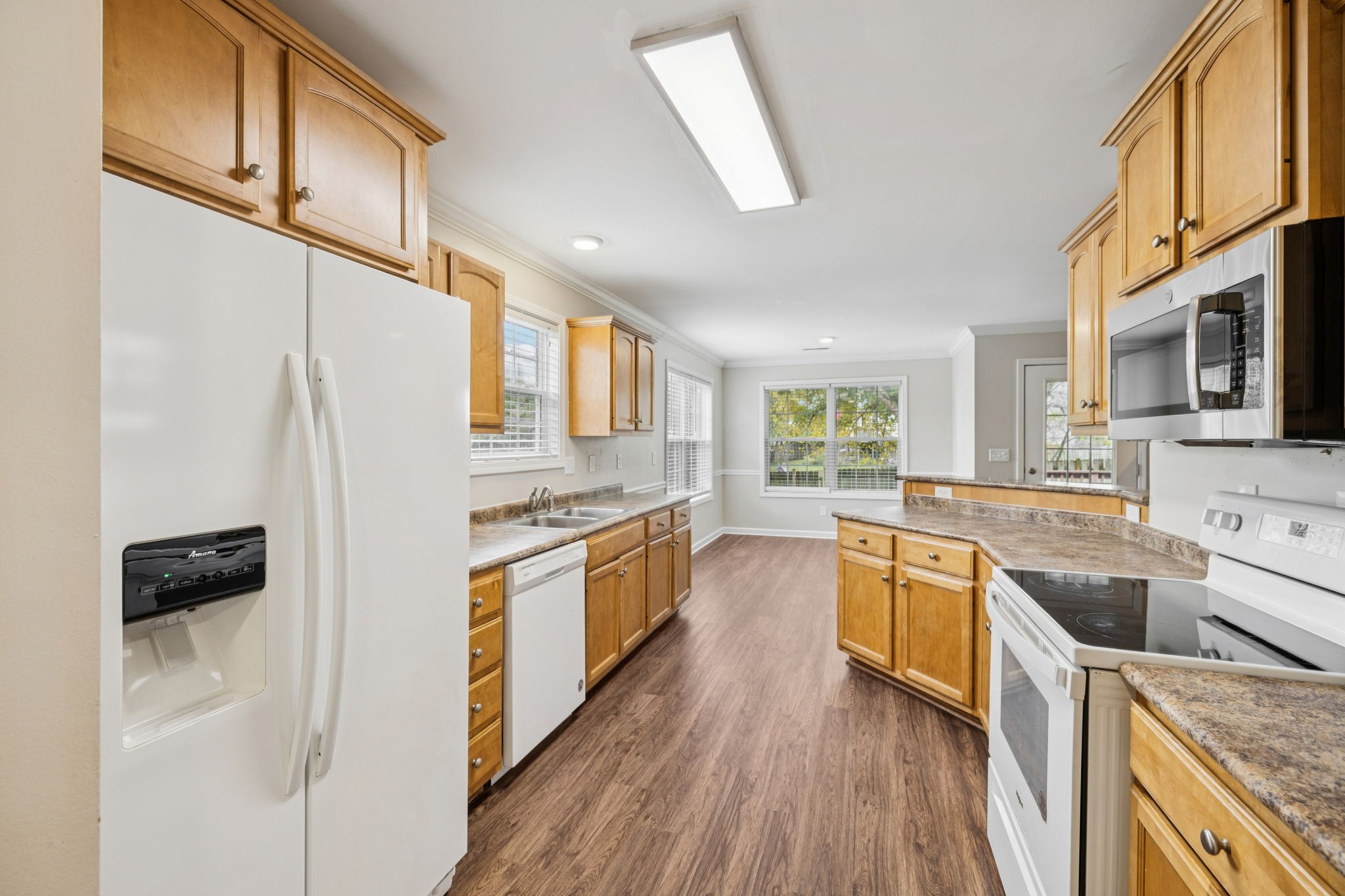 1305 Chapman Court Spring Hill, TN 37174 - Photo 23 of 53 a large kitchen with stainless steel appliances granite countertop a stove a sink and a refrigerator