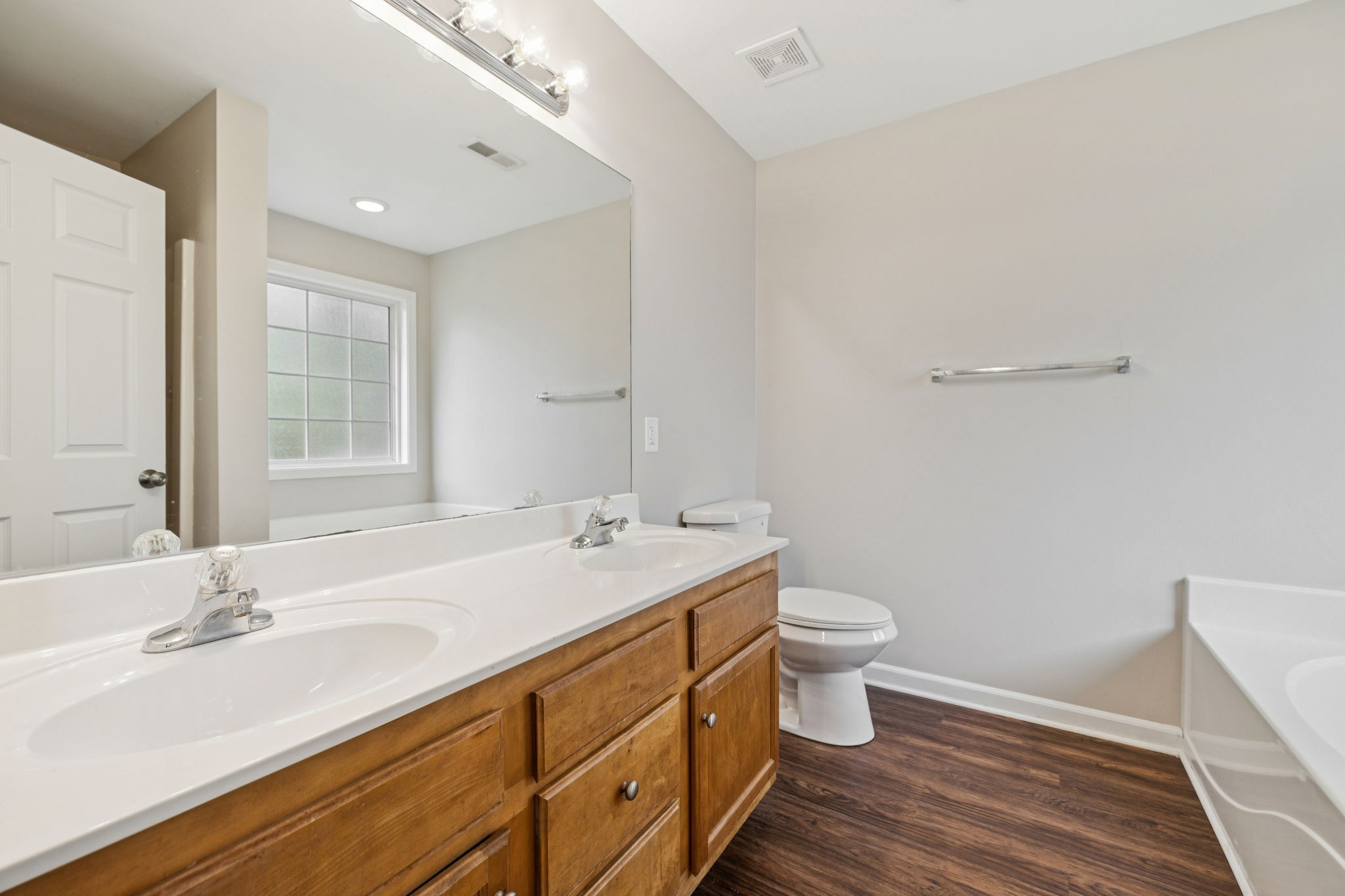 1305 Chapman Court Spring Hill, TN 37174 - Photo 41 of 53 a bathroom with a double vanity sink toilet and a mirror