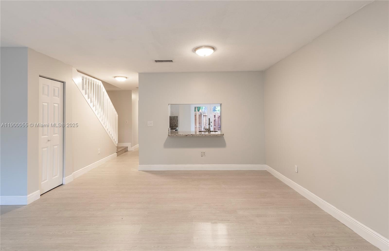 14237 Southwest 94th Cir Lane, Unit 101 Miami, FL 33186 - Photo 13 of 34 an empty room with a empty space and windows