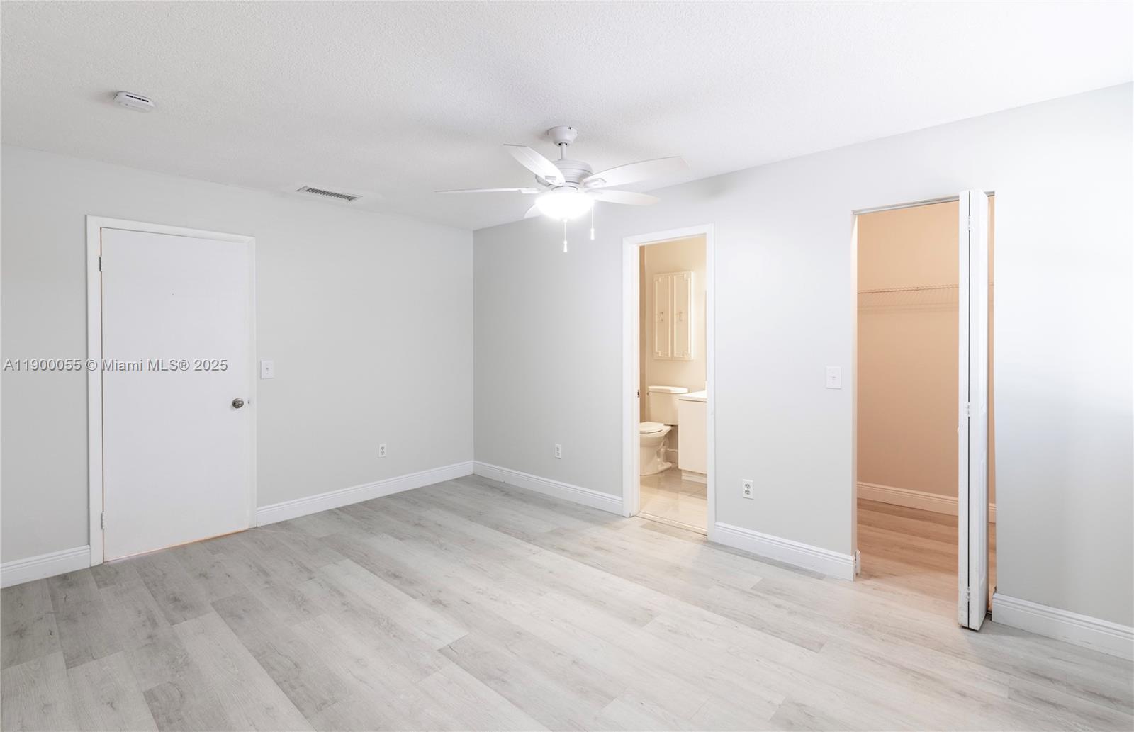 14237 Southwest 94th Cir Lane, Unit 101 Miami, FL 33186 - Photo 15 of 34 an empty room with closet and a ceiling fan