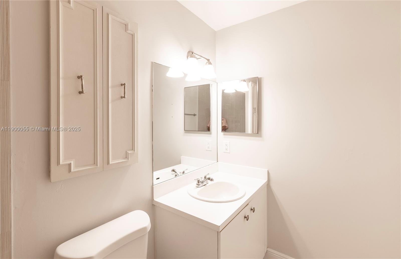 14237 Southwest 94th Cir Lane, Unit 101 Miami, FL 33186 - Photo 18 of 34 a bathroom with a sink and a mirror