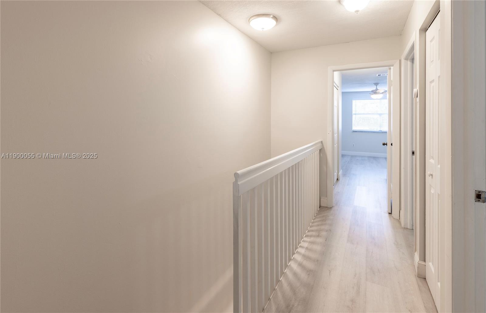 14237 Southwest 94th Cir Lane, Unit 101 Miami, FL 33186 - Photo 19 of 34 a view of a hallway with wooden floor
