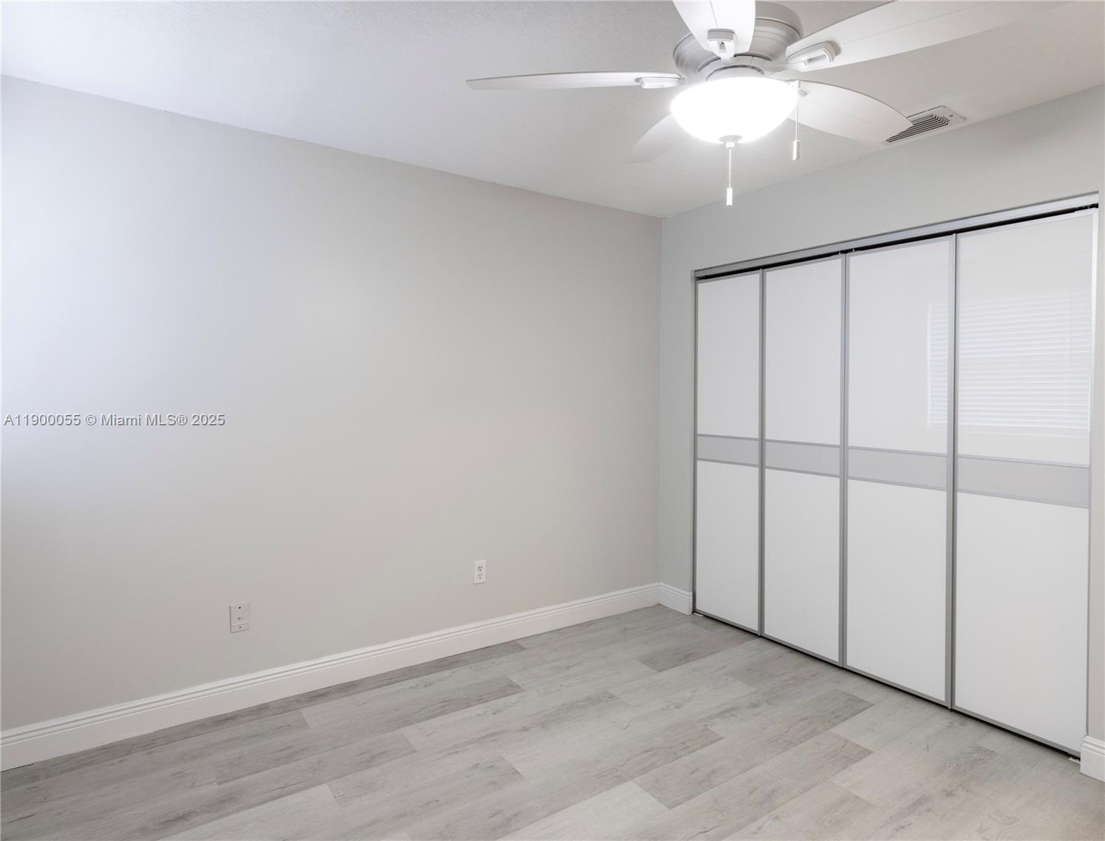 14237 Southwest 94th Cir Lane, Unit 101 Miami, FL 33186 - Photo 22 of 34 wooden floor in an empty room