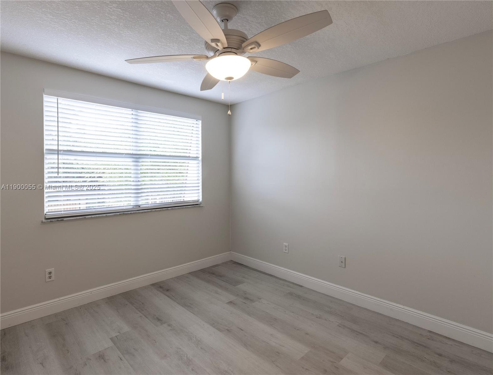 14237 Southwest 94th Cir Lane, Unit 101 Miami, FL 33186 - Photo 24 of 34 an empty room with a window