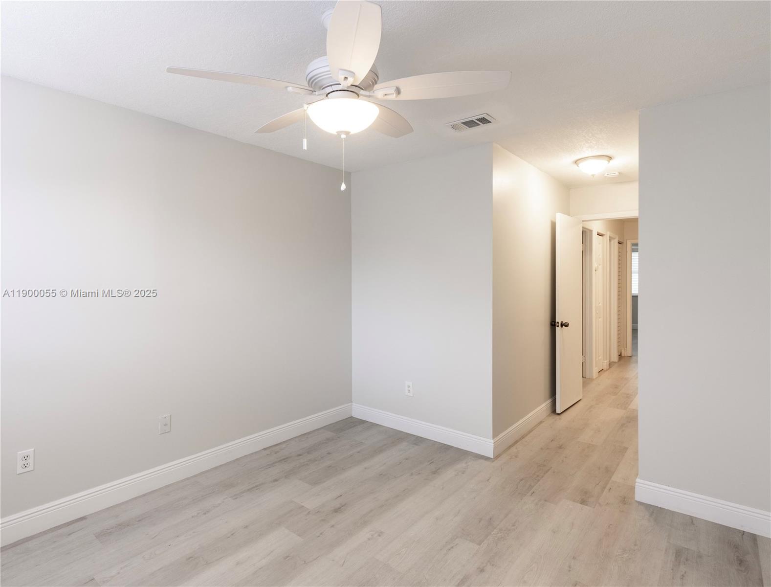 14237 Southwest 94th Cir Lane, Unit 101 Miami, FL 33186 - Photo 25 of 34 a view of a room with wooden floor
