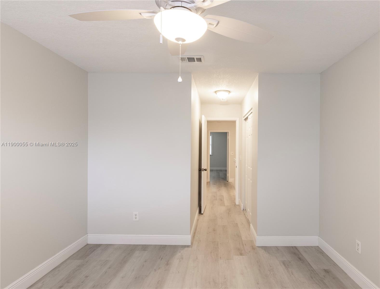 14237 Southwest 94th Cir Lane, Unit 101 Miami, FL 33186 - Photo 26 of 34 a view of a room with wooden floor and a window