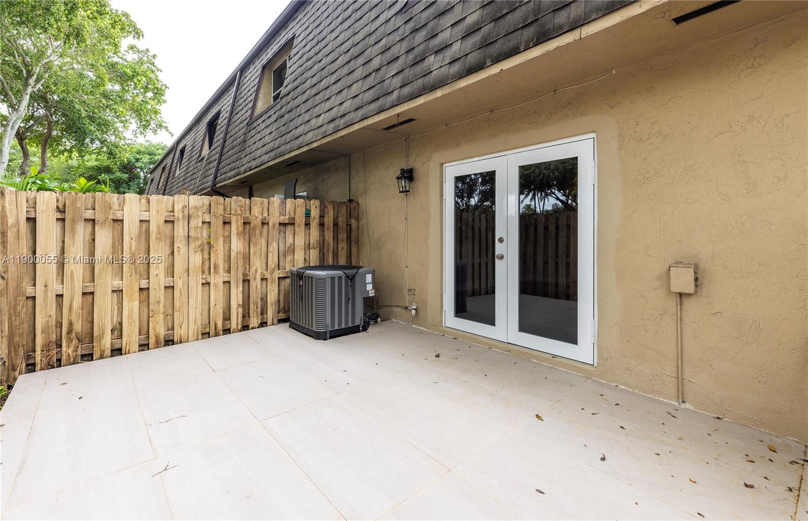 14237 Southwest 94th Cir Lane, Unit 101 Miami, FL 33186 - Photo 29 of 34 a view of a house with a wooden fence