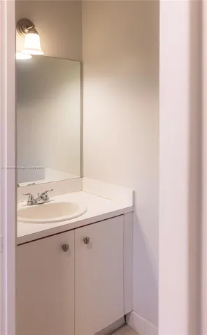 a kitchen with granite countertop a refrigerator and a sink