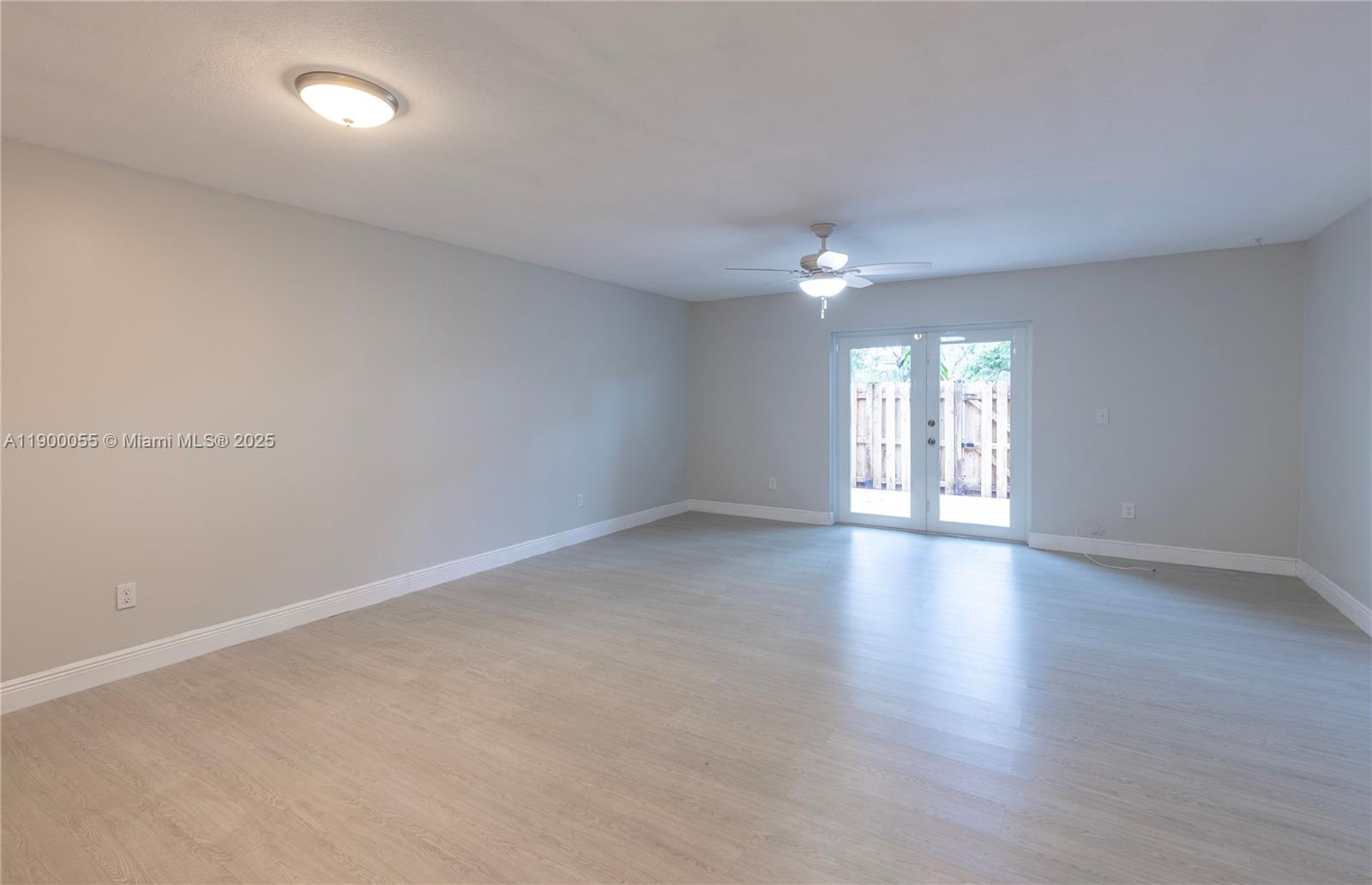 14237 Southwest 94th Cir Lane, Unit 101 Miami, FL 33186 - Photo 10 of 34 wooden floor in an empty room with a window