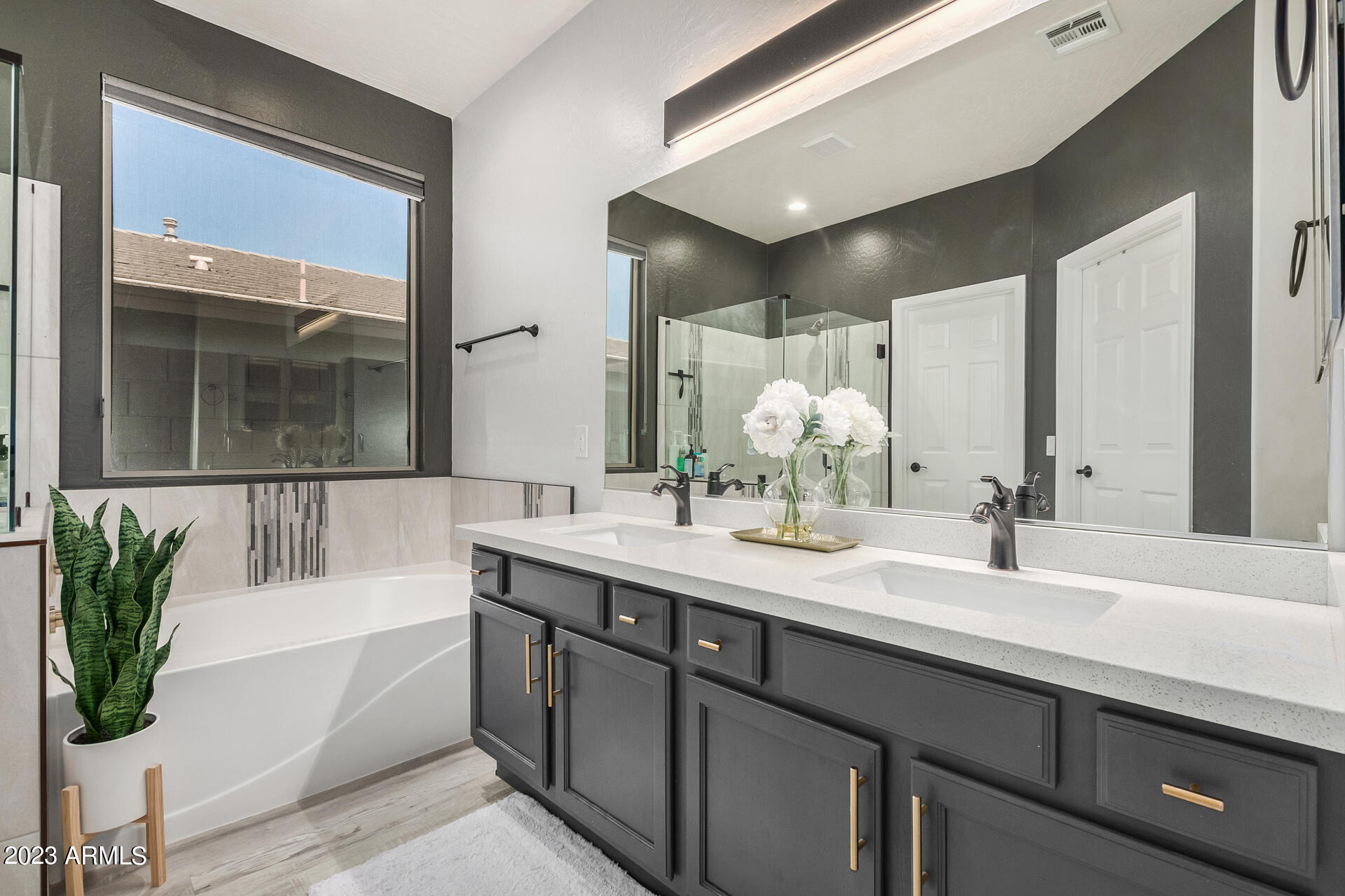 17560 West E Wind Avenue Goodyear, AZ 85338 - Photo 12 of 30 a bathroom with a tub a sink and mirror