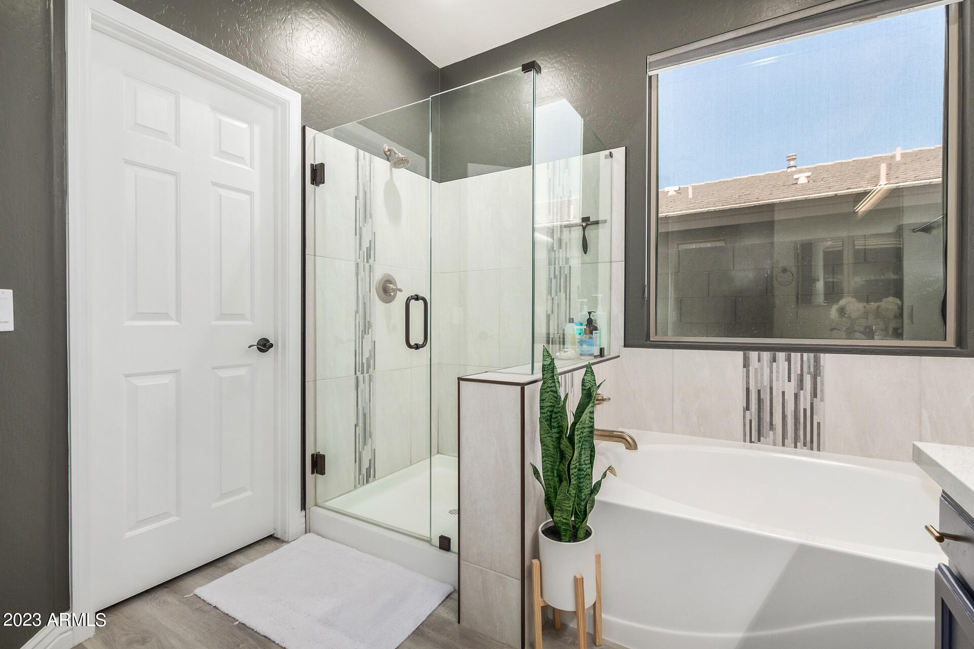 17560 West E Wind Avenue Goodyear, AZ 85338 - Photo 13 of 30 a bathroom with a bathtub and a shower