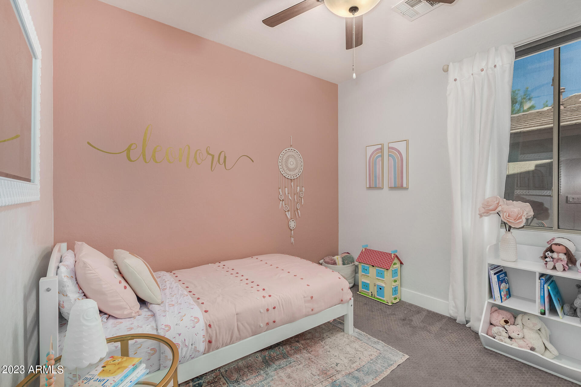 17560 West E Wind Avenue Goodyear, AZ 85338 - Photo 14 of 30 a bedroom with a bed and a book shelf