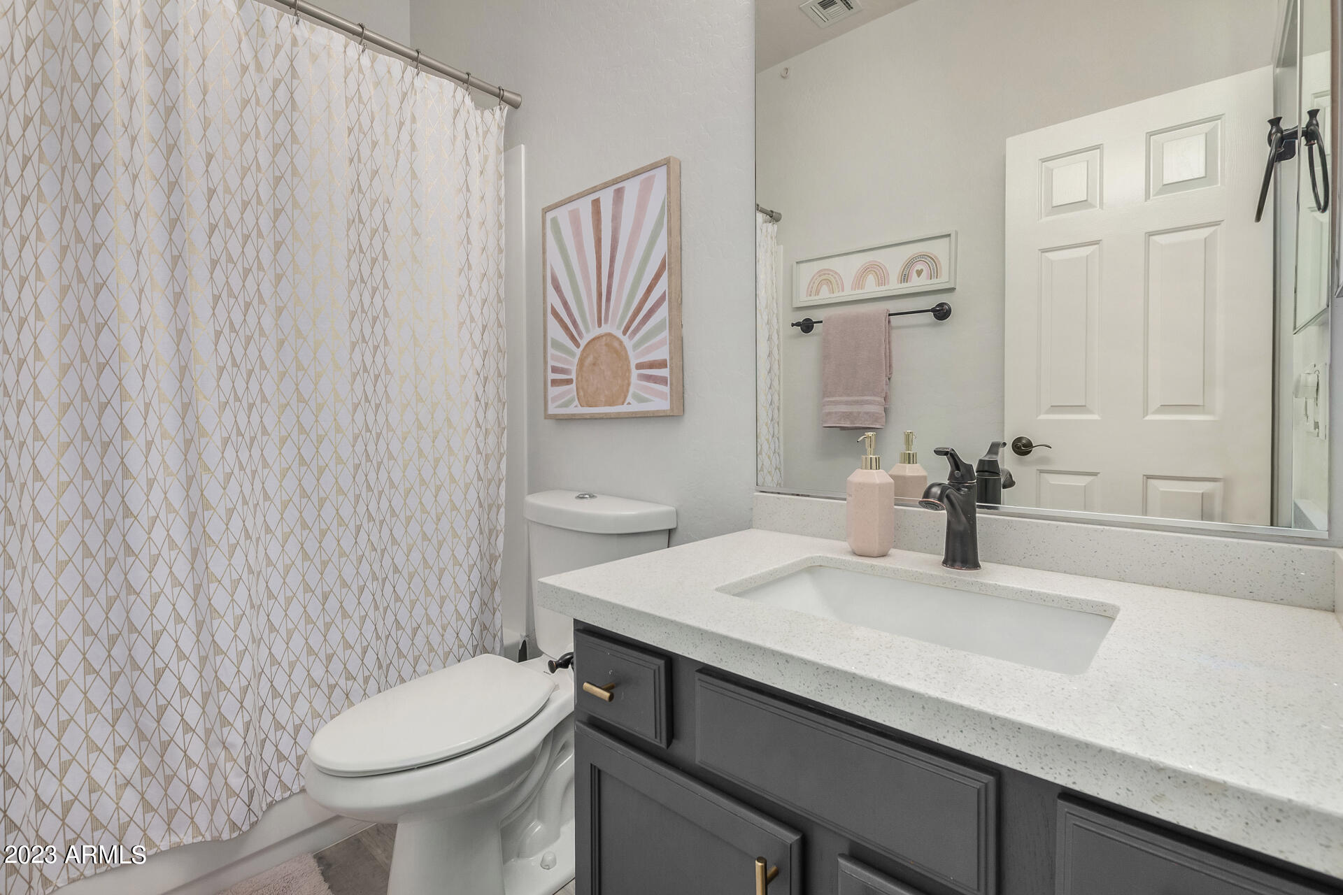 17560 West E Wind Avenue Goodyear, AZ 85338 - Photo 16 of 30 a bathroom with a sink a toilet and a mirror