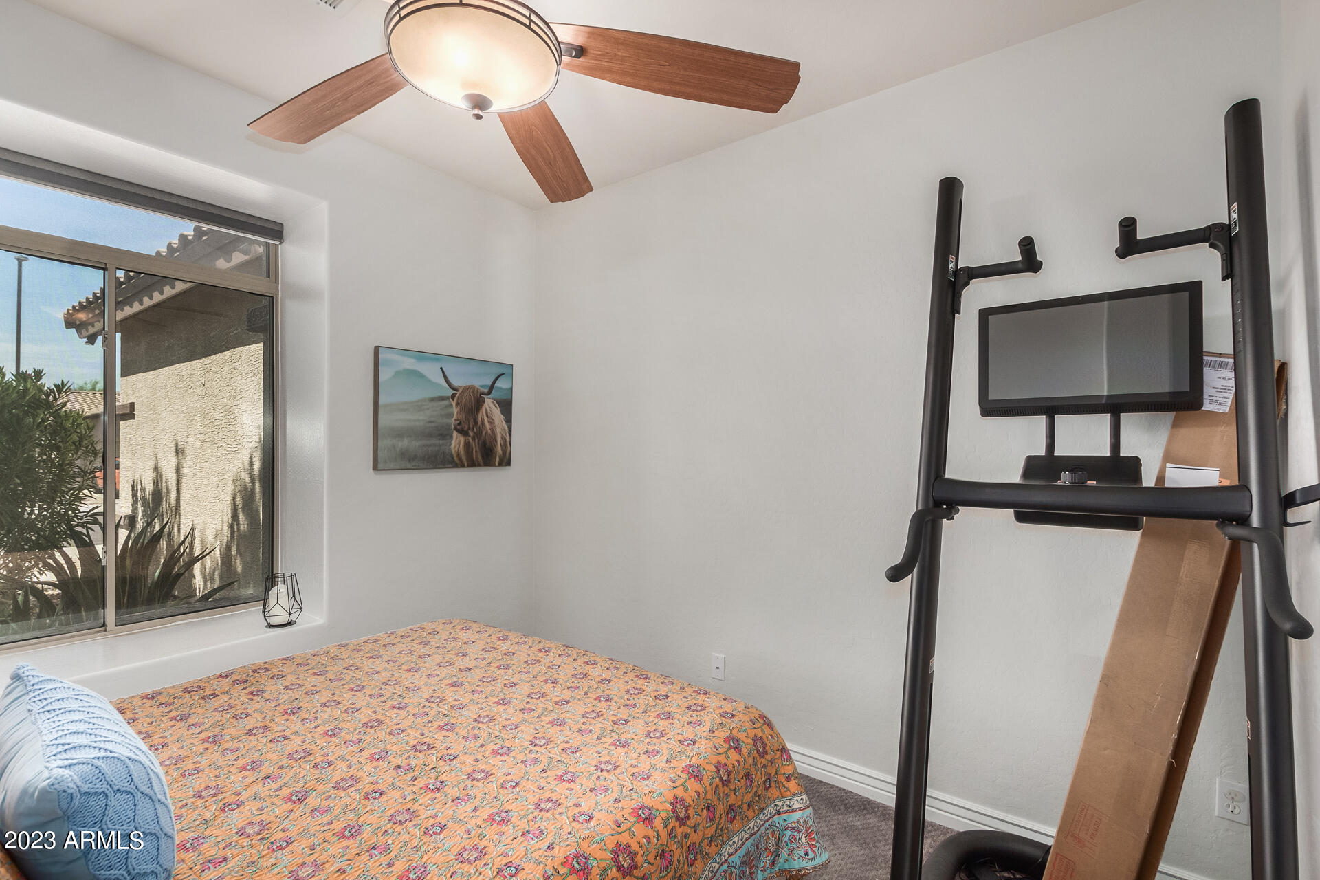 17560 West E Wind Avenue Goodyear, AZ 85338 - Photo 17 of 30 a bedroom with a bed and a flat screen tv
