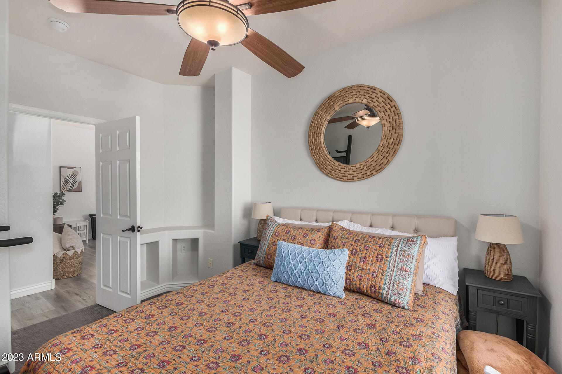 17560 West E Wind Avenue Goodyear, AZ 85338 - Photo 18 of 30 a bedroom with a bed and a chandelier