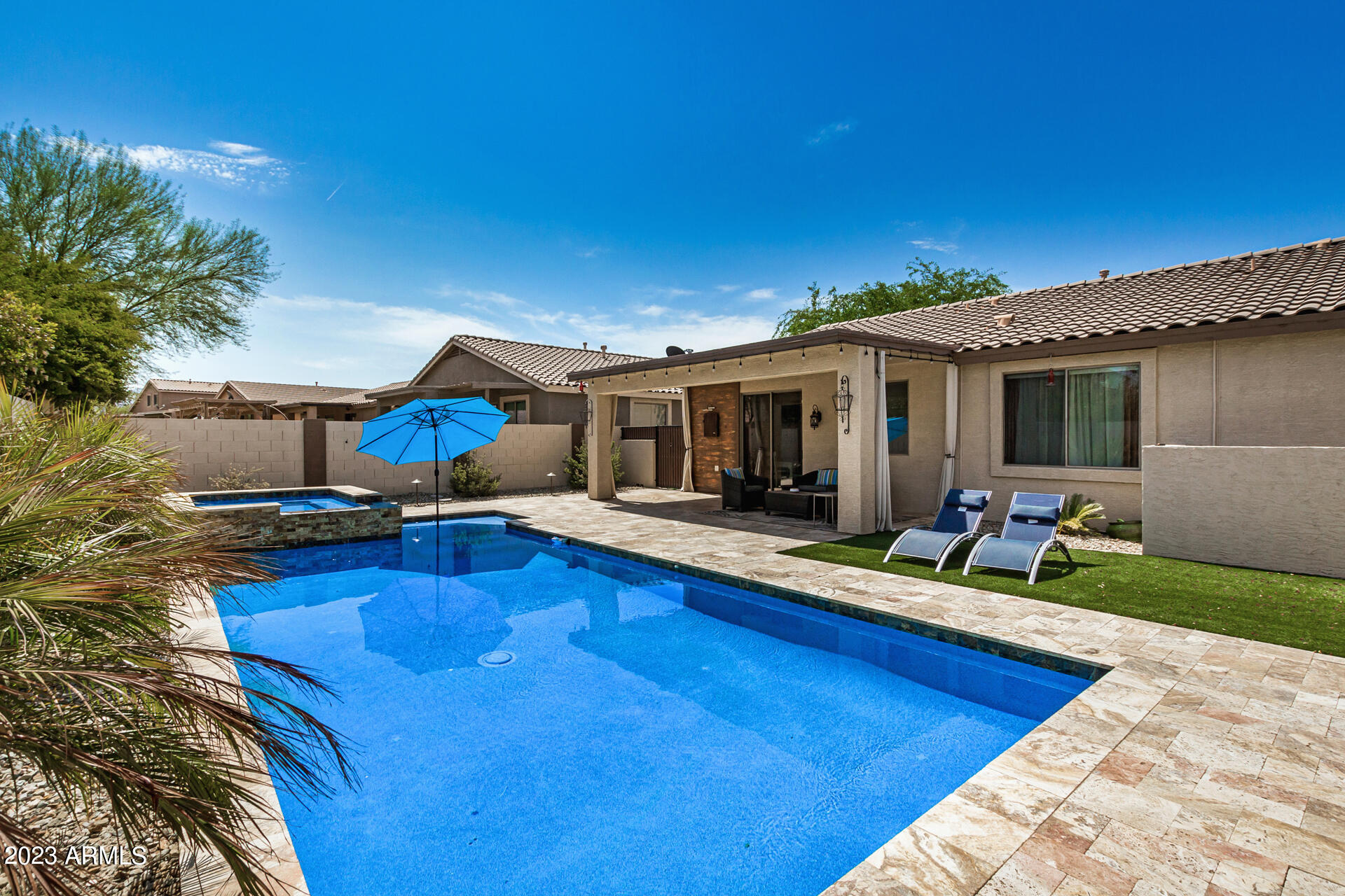 17560 West E Wind Avenue Goodyear, AZ 85338 - Photo 22 of 30 a view of a house with pool and chairs