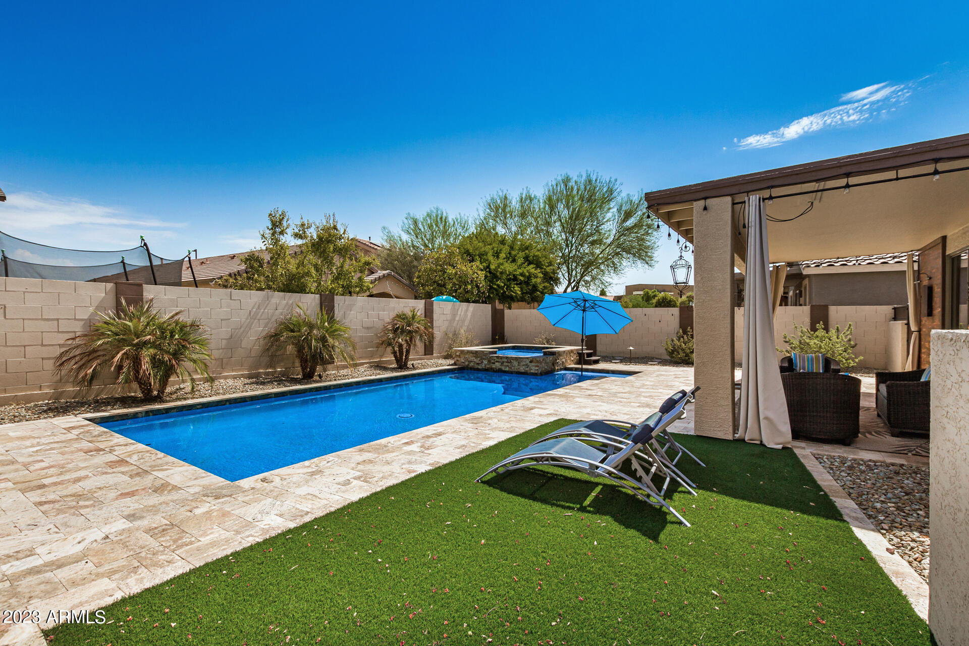 17560 West E Wind Avenue Goodyear, AZ 85338 - Photo 23 of 30 a view of a swimming pool with lounge chair
