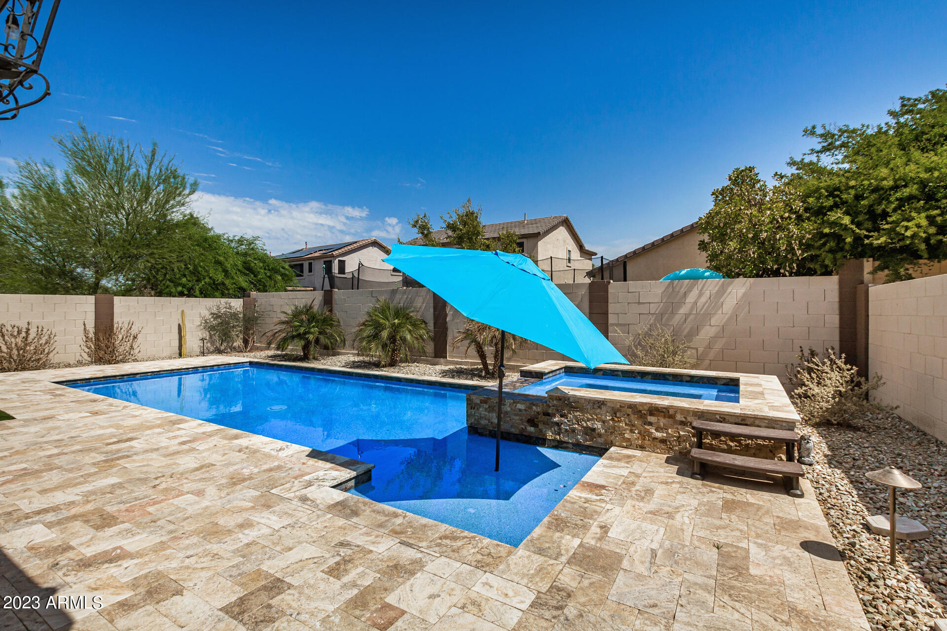 17560 West E Wind Avenue Goodyear, AZ 85338 - Photo 24 of 30 a swimming pool with outdoor seating and wooden fence