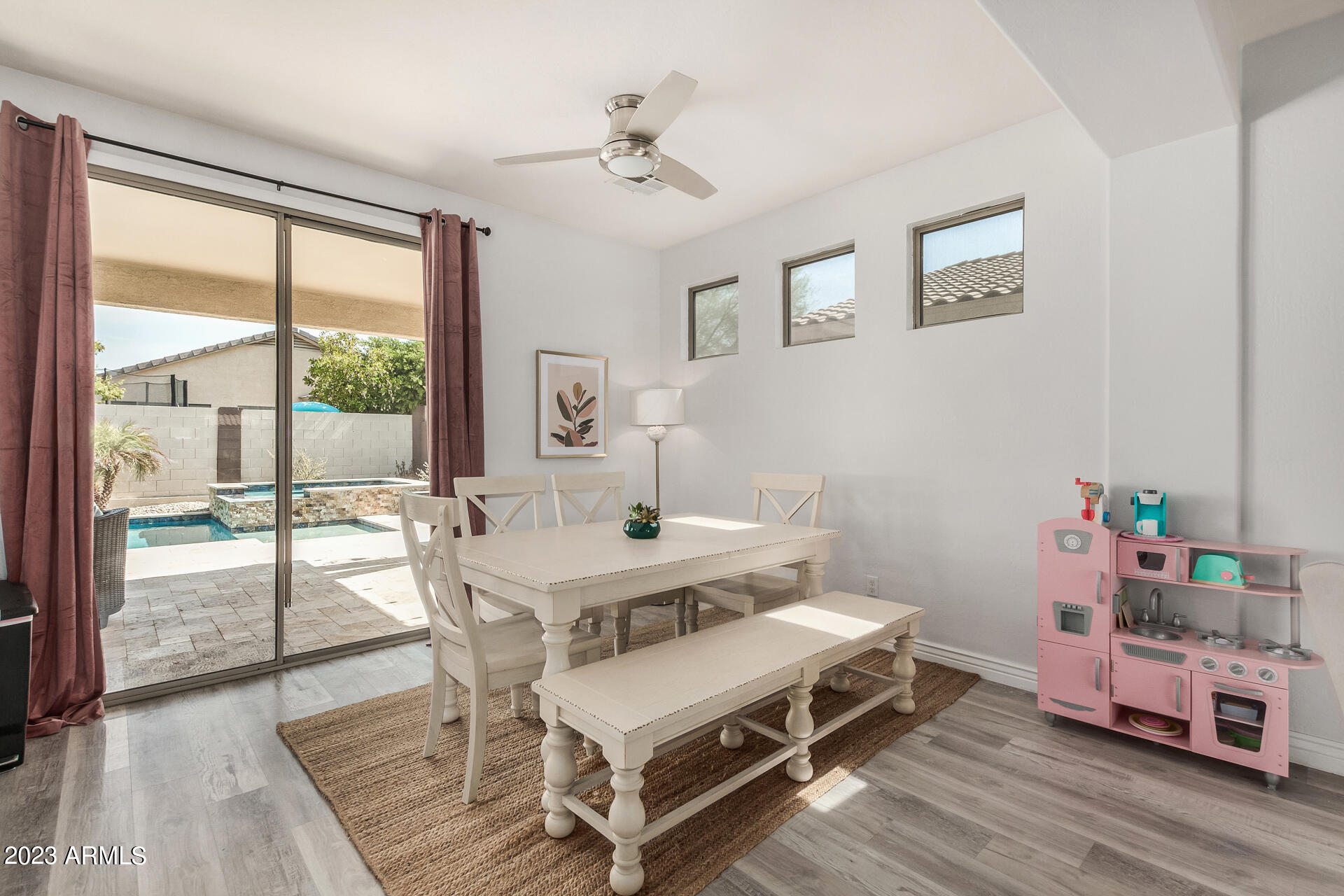 17560 West E Wind Avenue Goodyear, AZ 85338 - Photo 5 of 30 a view of a dining room with furniture a chandelier and wooden floor