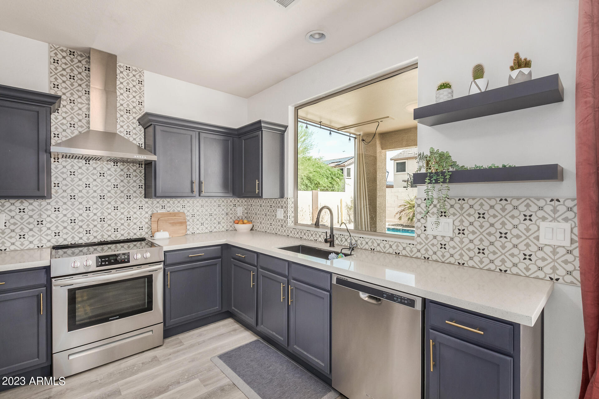 17560 West E Wind Avenue Goodyear, AZ 85338 - Photo 7 of 30 a kitchen with a sink stove and microwave