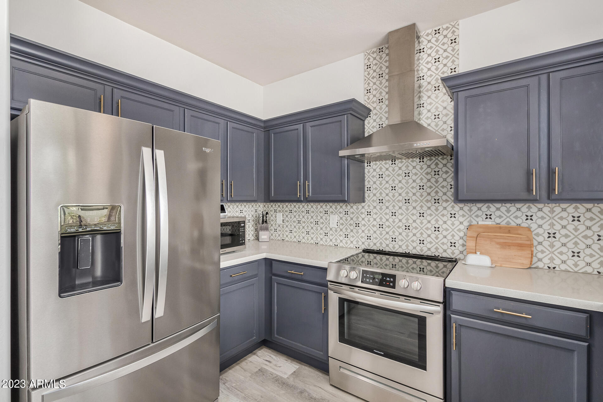 17560 West E Wind Avenue Goodyear, AZ 85338 - Photo 8 of 30 a kitchen with stainless steel appliances a sink stove and refrigerator