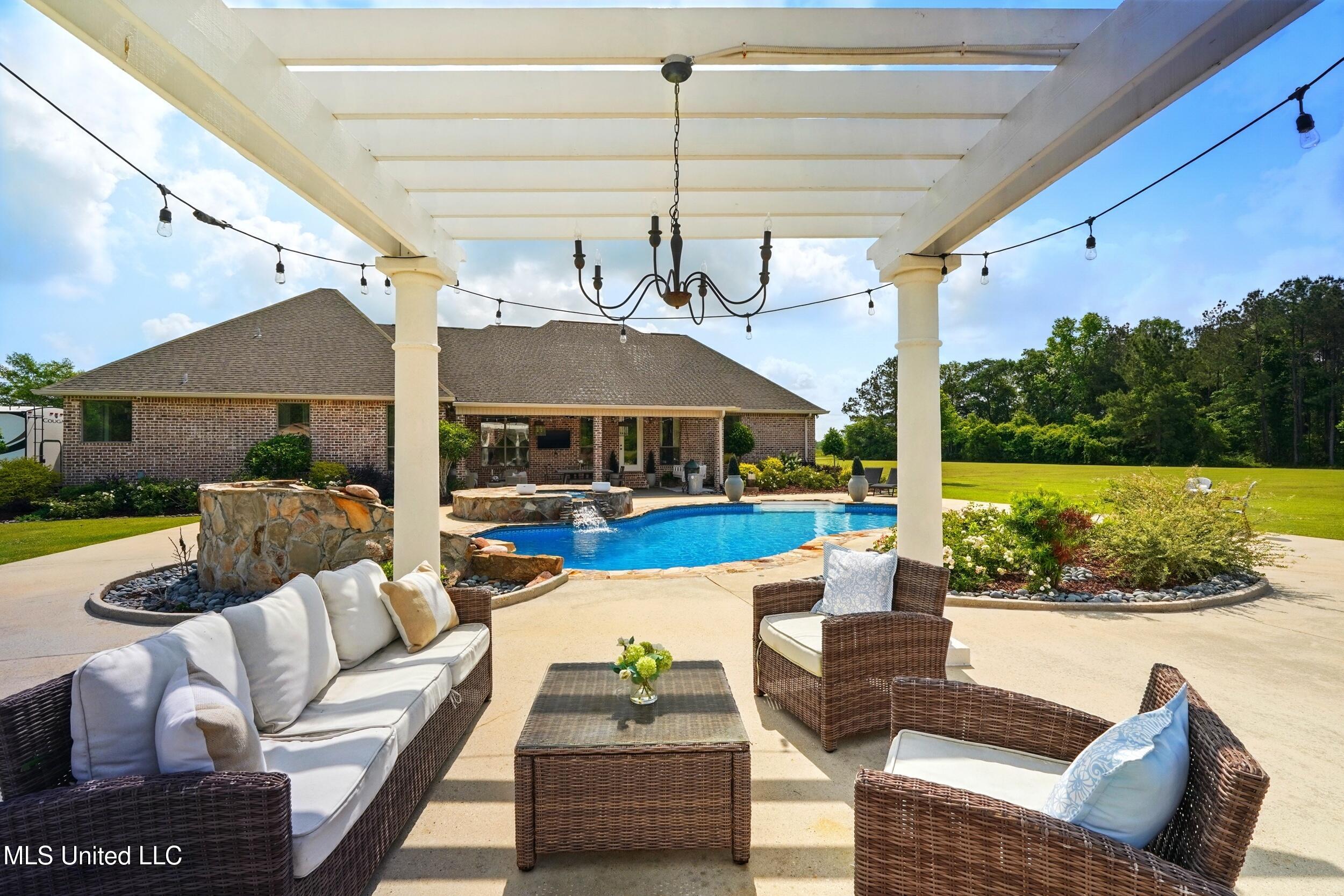 7 Jim Pearson Road Picayune, MS 39466 - Photo 29 of 46 30_outside fireplace looking at pool 1