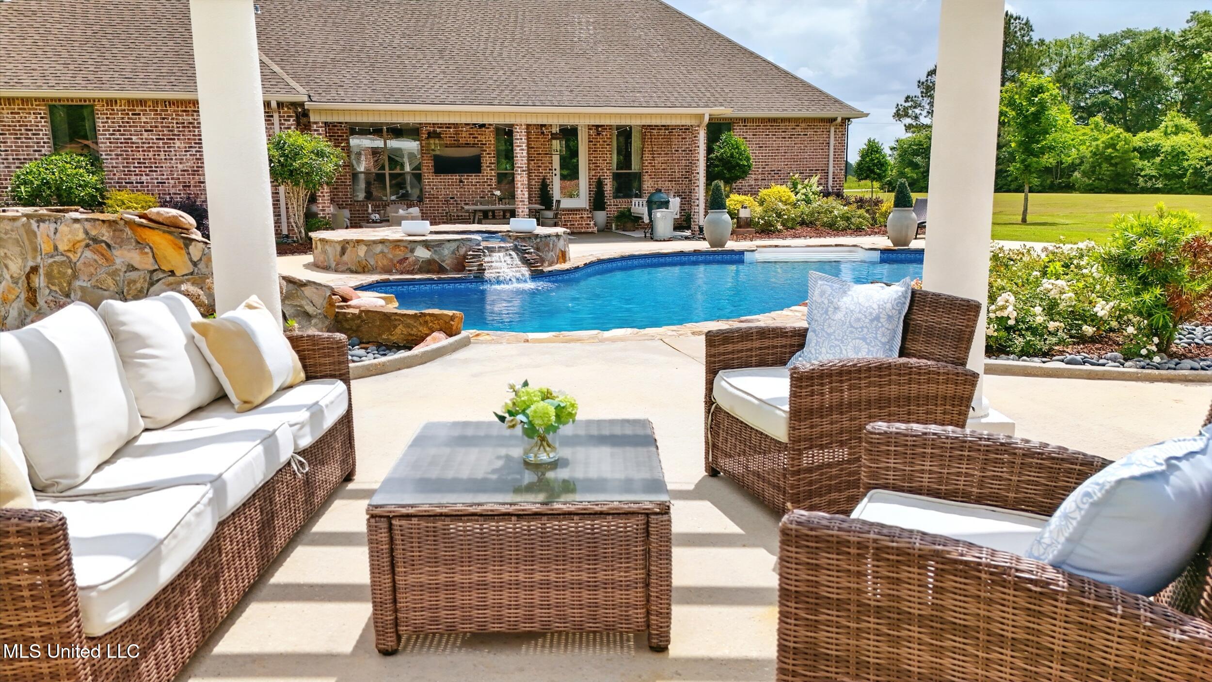 7 Jim Pearson Road Picayune, MS 39466 - Photo 34 of 46 5_outside fireplace looking at pool 2