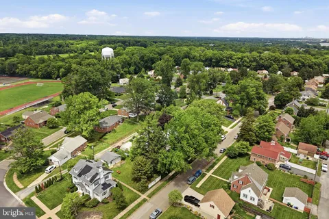 an aerial view of a houses with a yard
