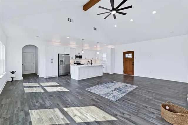 a living room with hard wood floor and a rug