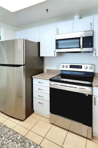 a kitchen with appliances and cabinets