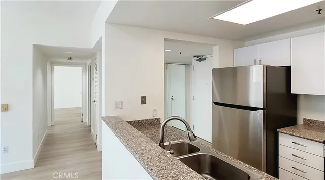 a kitchen with a refrigerator and a sink