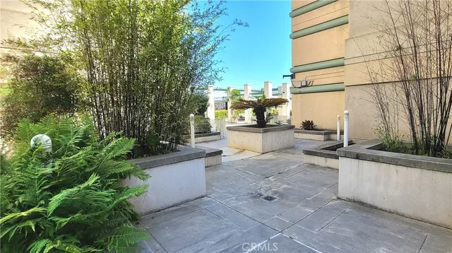 a view of a patio with table and chairs and potted plants