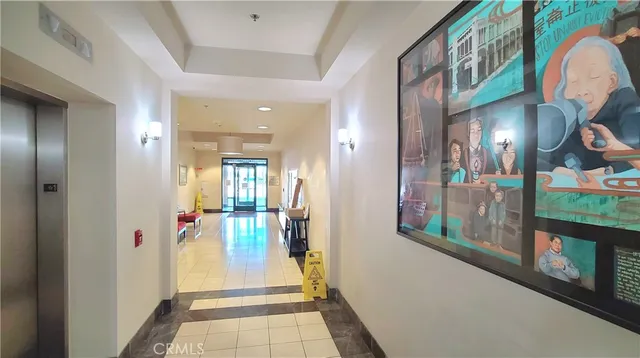 a view of a hallway and a livingroom with furniture
