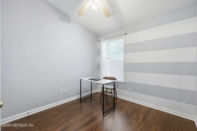 a view of a room that has a table and chair in it