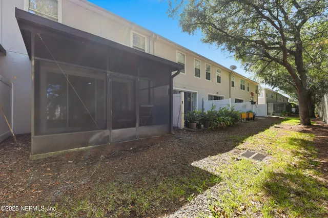 a view of a white house with a yard