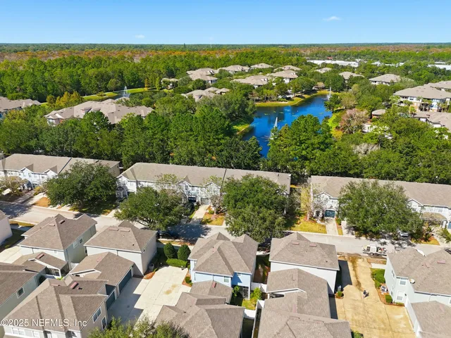an aerial view of residential houses with outdoor space and swimming pool