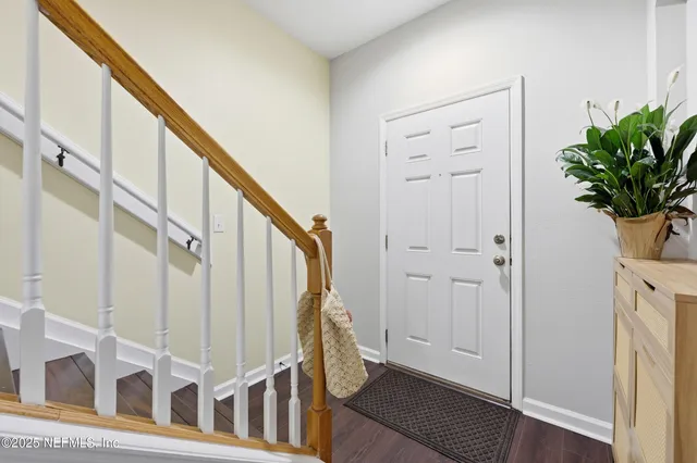 a view of staircase with white walls and a window