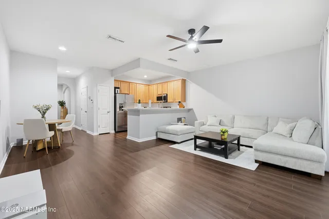 a living room with furniture and a wooden floor